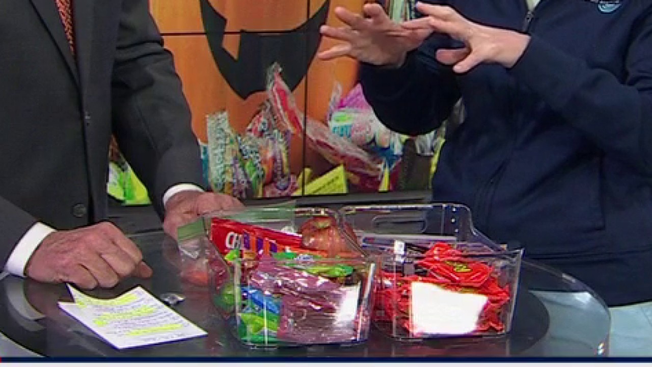 Children in costumes celebrating Halloween while collecting candy